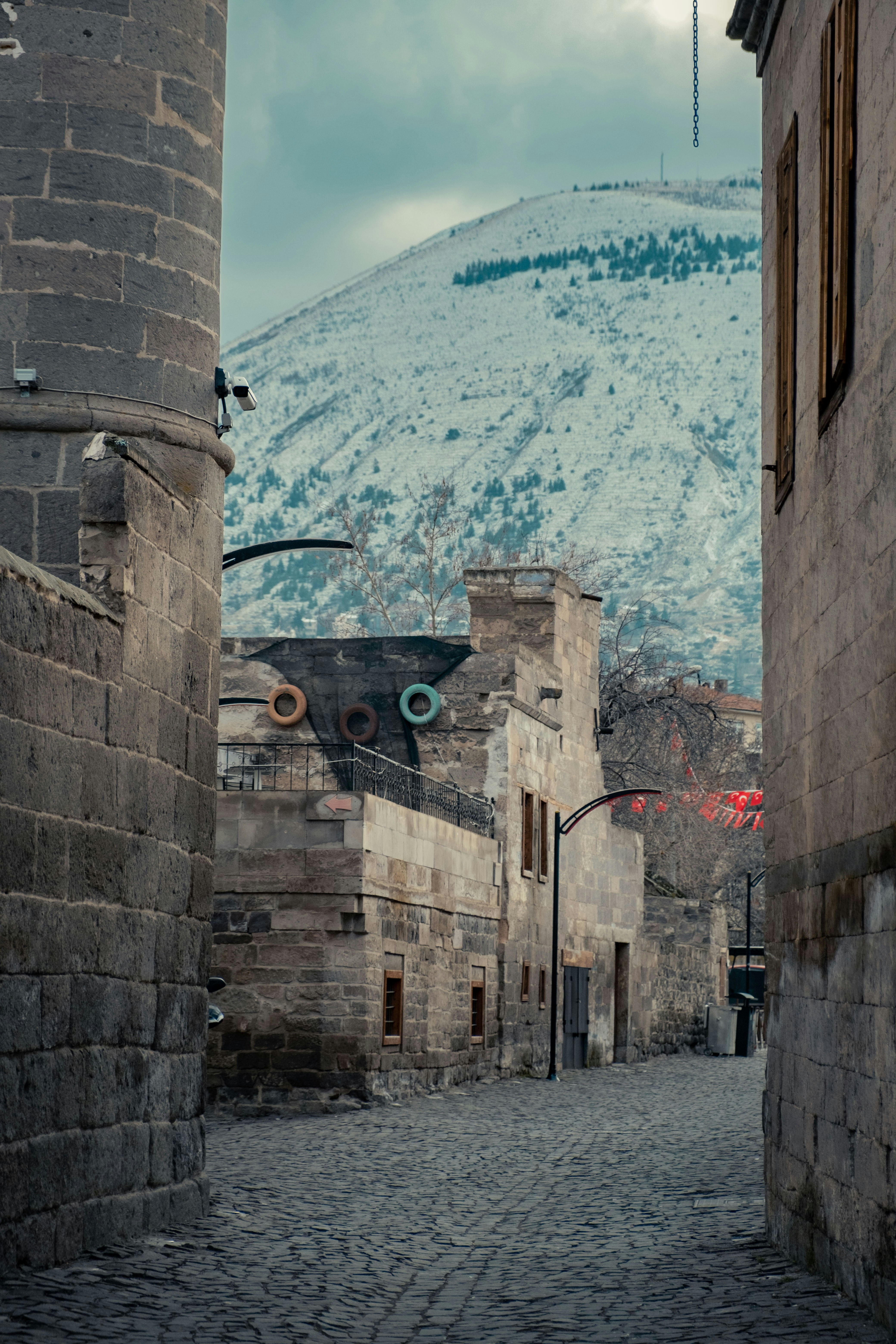 an alley way with a mountain in the background